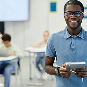 Student reading book in library wearing mask
