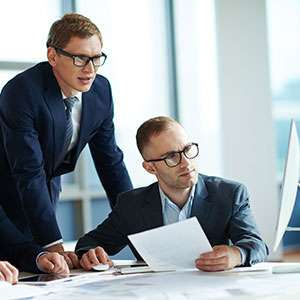 Student reading book in library wearing mask