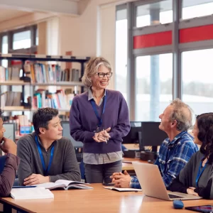 Student reading book in library wearing mask